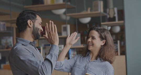 two colleagues high five it jobs timetoact group